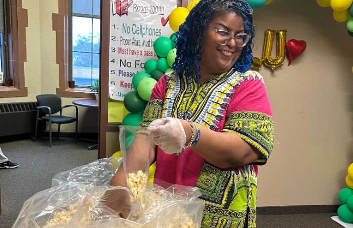  Counselor making popcorn bags.